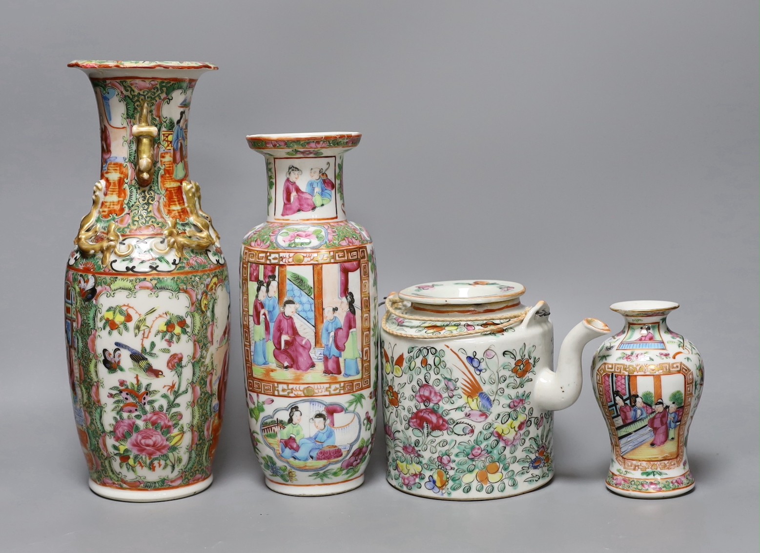 Three Chinese famille rose vases and a teapot, late 19th/early 20th century, tallest vase 29.5 cms high